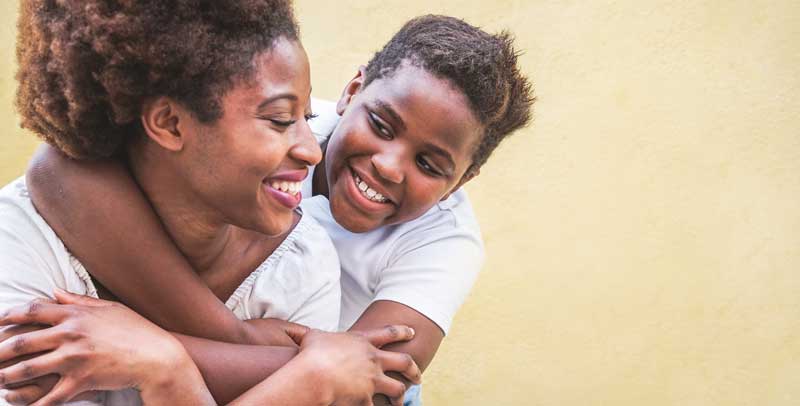 mother being hugged by her foster child.