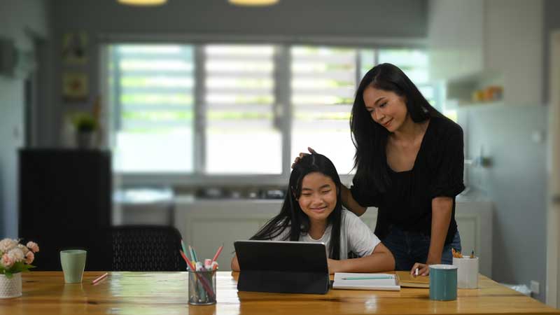 foster mother helping child with homework.