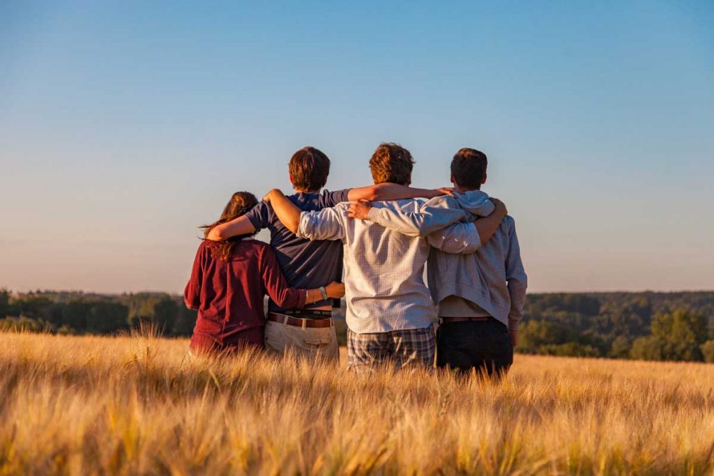 Kids outside overlooking a field.