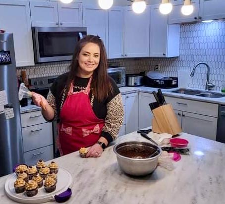 Smiling woman in a kitchen, baking.