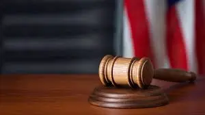 Gavel on a judge's bench with American flag in the background