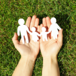 Hands holding a paper family chain