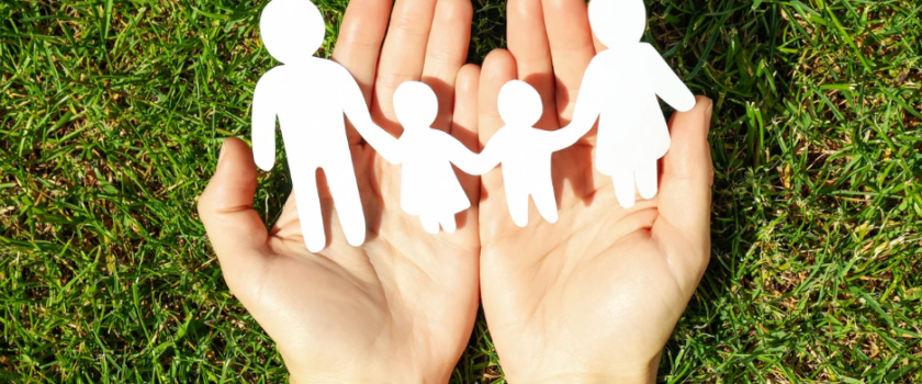 Hands holding a paper family chain